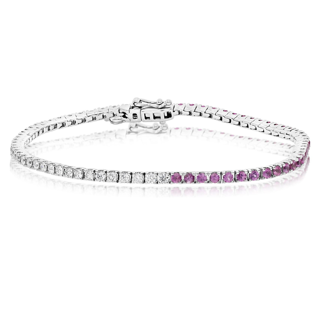 A tennis bracelet featuring round diamonds and pink sapphires set in 14K white gold.